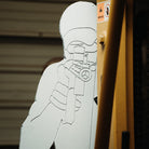 White silhouette target on a yellow background.