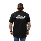 Person wearing a black t-shirt with 'illicit' logo and text on the back, standing against a white background.