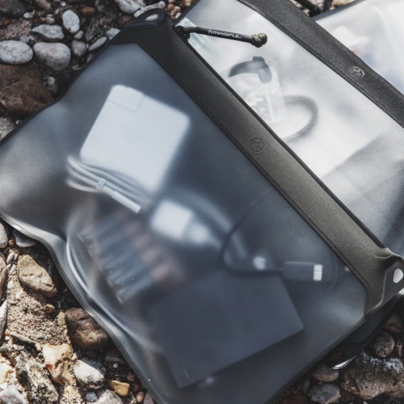 Magpul DAKA Window Pouch Medium Black filled with electronics tools and accessories visible through translucent window
