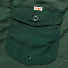 Close-up of a green pocket with a brand label.