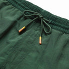 Close-up of green shorts with a drawstring on a white background