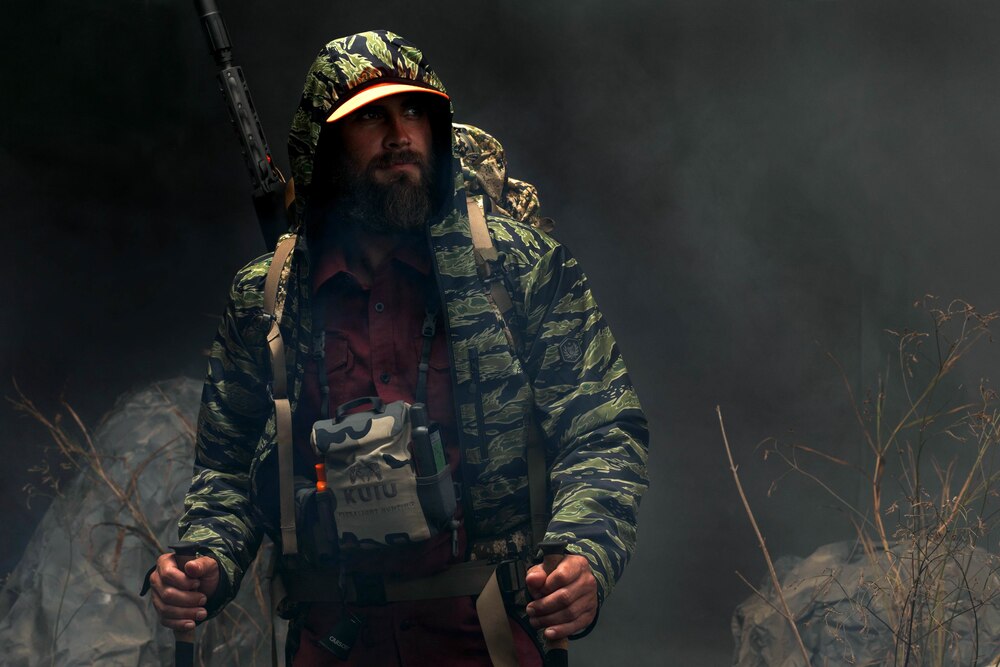 man in field wearing Tactical Distributors Stretch Range Jacket