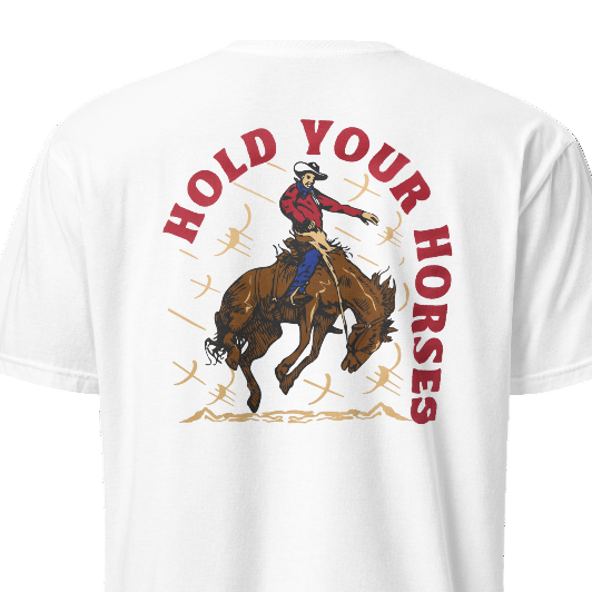 White t-shirt with a graphic of a cowboy on a horse and text 'Hold Your Horses' on a white background