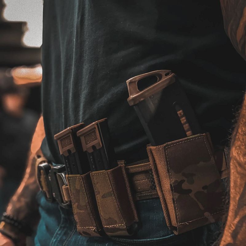 Ranger Green GBRS Group Double Pistol Magazine Pouch mounted on a duty belt during live range training, showing real world use, fast magazine access, and streamlined retention for tactical and law enforcement applications.