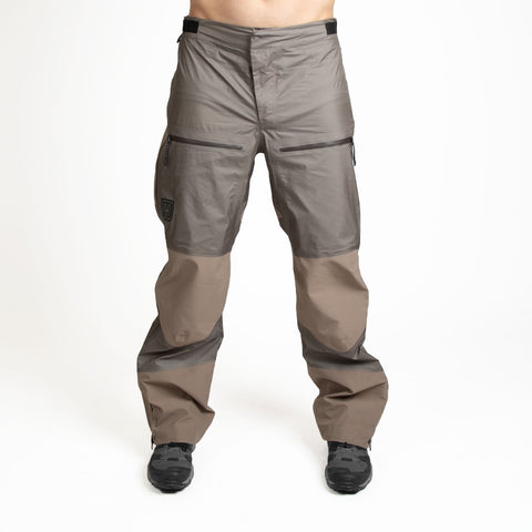 Man wearing weatherproof pants in tan from MTHD Mountain eVent DVstorm DVexpedition Hardshell line