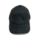 Free-standing baseball cap in black color with MTHD logo and brand name lettering in the center 